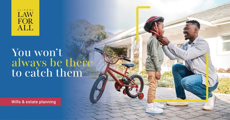 Father protecting his son by putting a helmet on before teaching him to ride bicycle