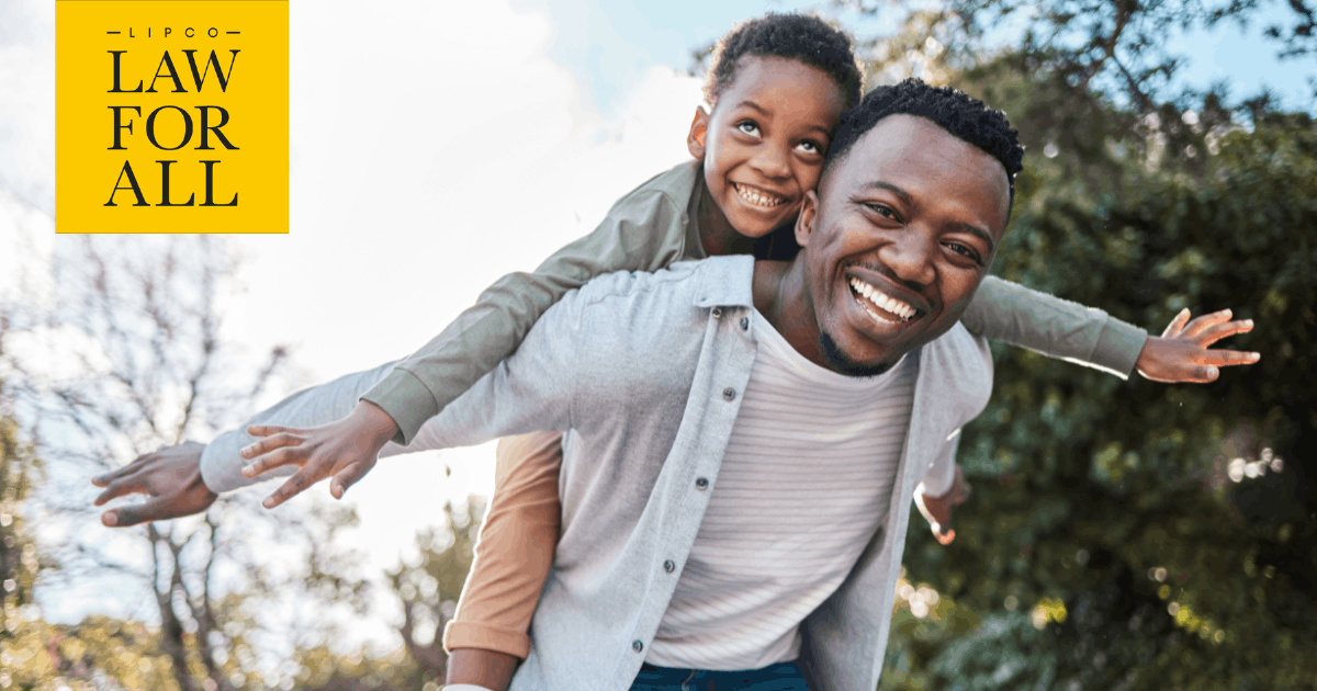Father and son laughing together outdoors, the kind of moment a will helps protect